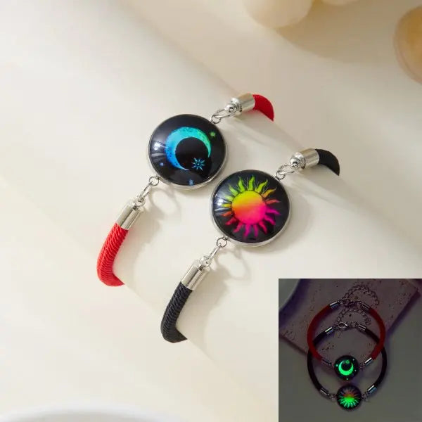 Two colorful sun and moon bracelets with glowing designs on a light background