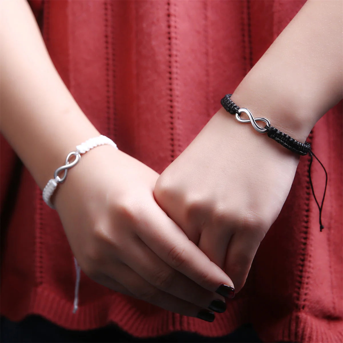 black and white infinity bracelet pair on wrists