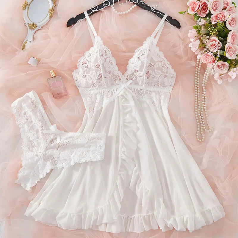 White lace nightdress and thong set displayed with pearls and mirror